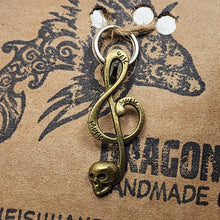 Load image into Gallery viewer, Large Brasstone Skull Treble Clef Zipper Pull
